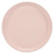 A close-up of a light pink Cambro round tray.