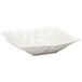 A white square bowl with crinkled edges.
