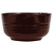A brown cast aluminum fruit bowl with a dark brown speckle pattern on a black rim.