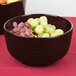 A Tablecraft Midnight Speckle cast aluminum fruit bowl filled with grapes on a table.