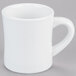 A close-up of a CAC white mug with a handle.