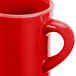 A close up of a CAC red Hartford mug with a handle.