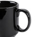 A close up of a black CAC Venice Stacking Mug with a handle.