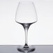 A close-up of a clear Chef & Sommelier wine glass on a table.