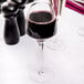 A Chef & Sommelier wine glass filled with red wine on a table.