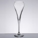 A close-up of a Chef & Sommelier clear glass flute with a thin stem on a table.