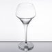 A clear Chef & Sommelier wine glass on a table.