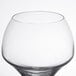 A close up of a clear Chef & Sommelier wine glass with a white background.