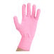 A hand wearing a pink Victorinox PerformanceFIT cut resistant glove with fingers extended.