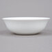 A white Arcoroc multi-usage bowl with a white rim on a gray surface.