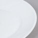 A close up of a white Arcoroc side plate with a small hole in the middle.