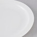 An Arcoroc white glass lunch plate with a narrow white rim.