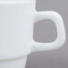 An Arcoroc white coffee cup with a handle.
