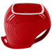 A red pitcher with a white interior and handle.