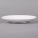 A CAC SHER-7 bone white porcelain plate on a gray surface.
