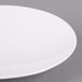 A close up of a CAC bone white porcelain round plate with a white rim.