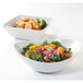 A Tuxton TuxTrendz bright white square china bowl filled with salad, shrimp, and oranges.