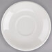A Tuxton eggshell white saucer with a circle on it.