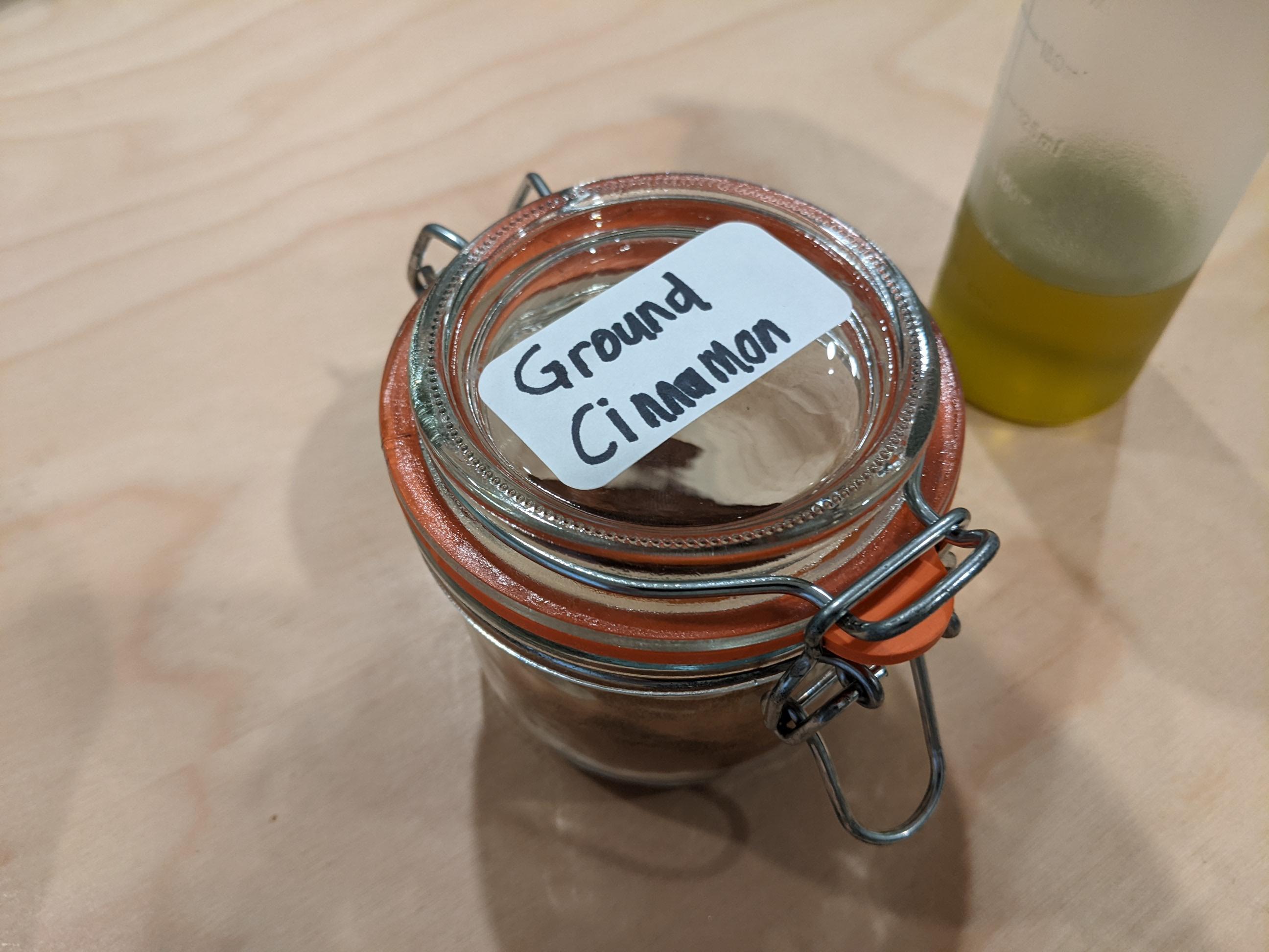 A spice jar with a removable label applied to it