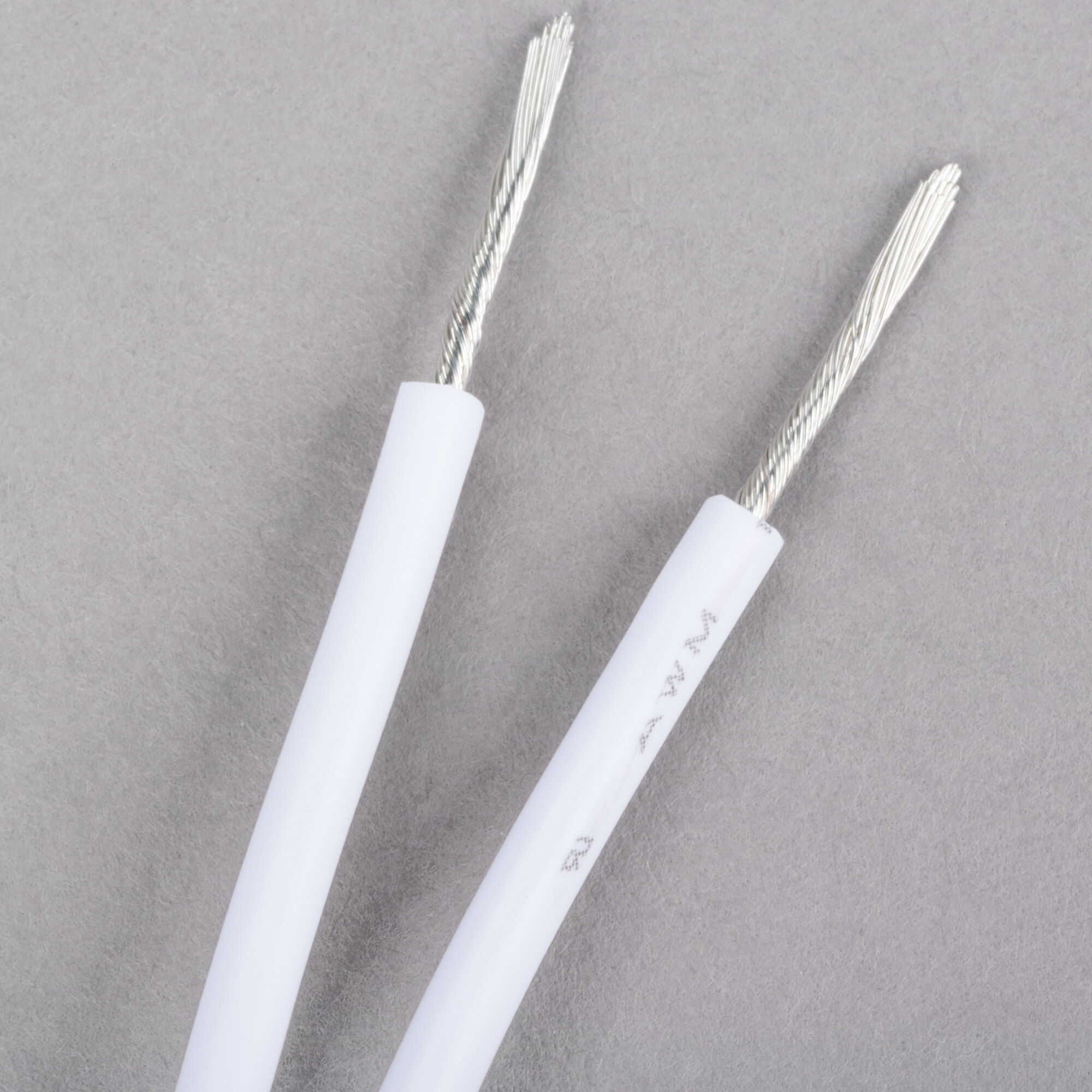 An Avantco fluorescent light socket assembly with two white wires connected to a silver connector.