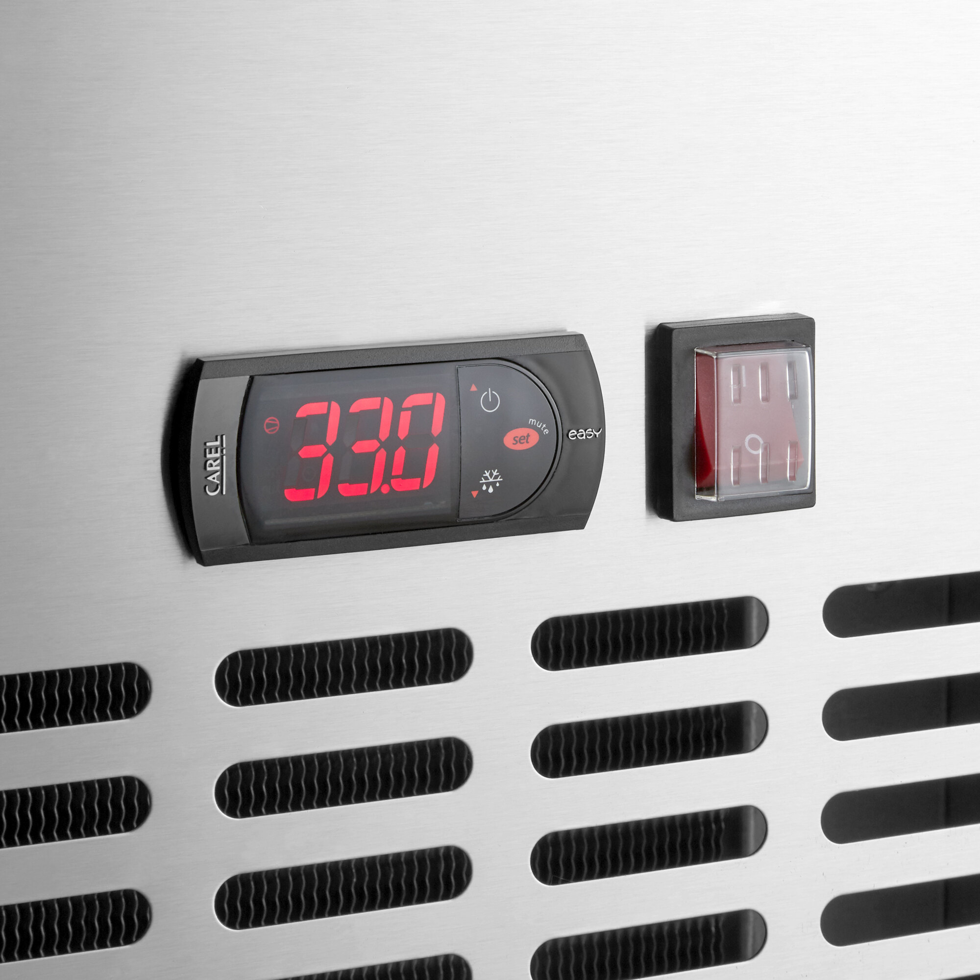 The digital clock on the stainless steel worktop of an Avantco refrigerator.