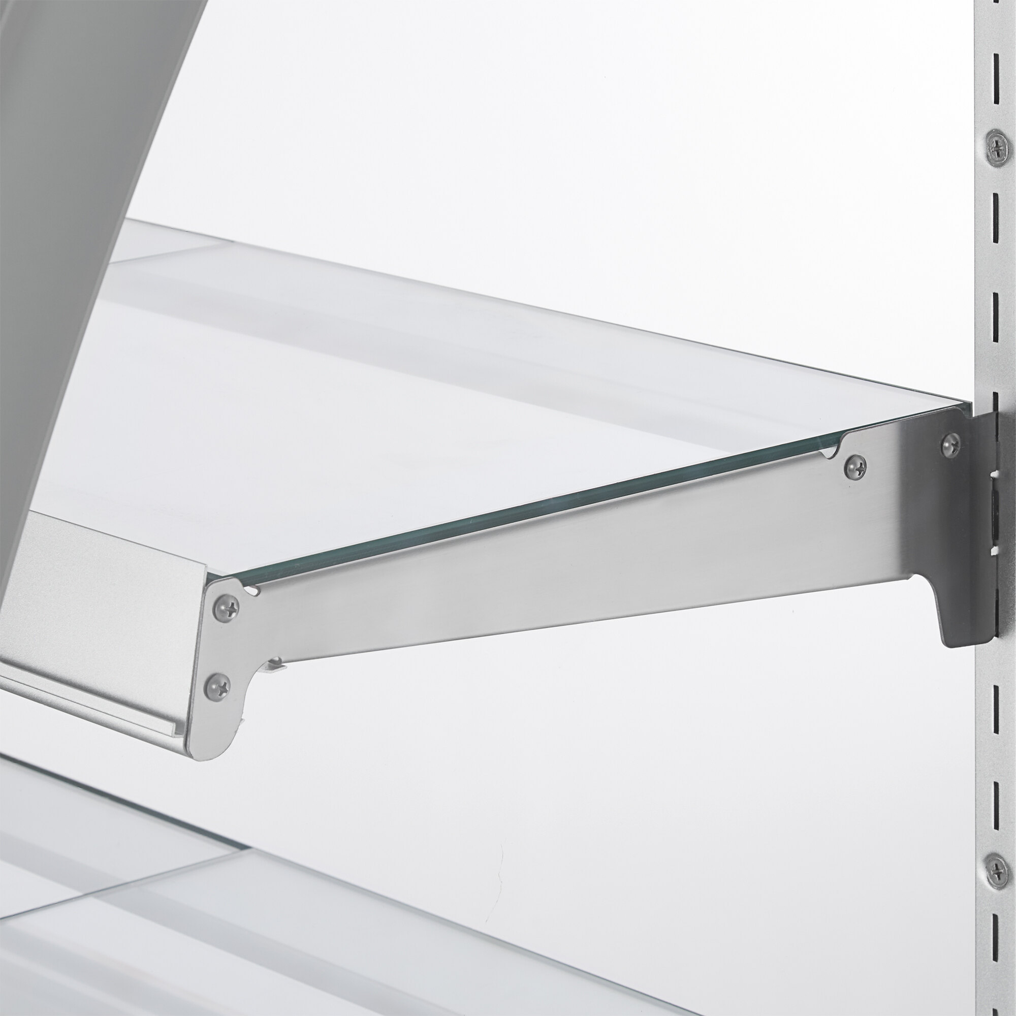 A glass shelf with metal supports inside a refrigerated bakery display case.