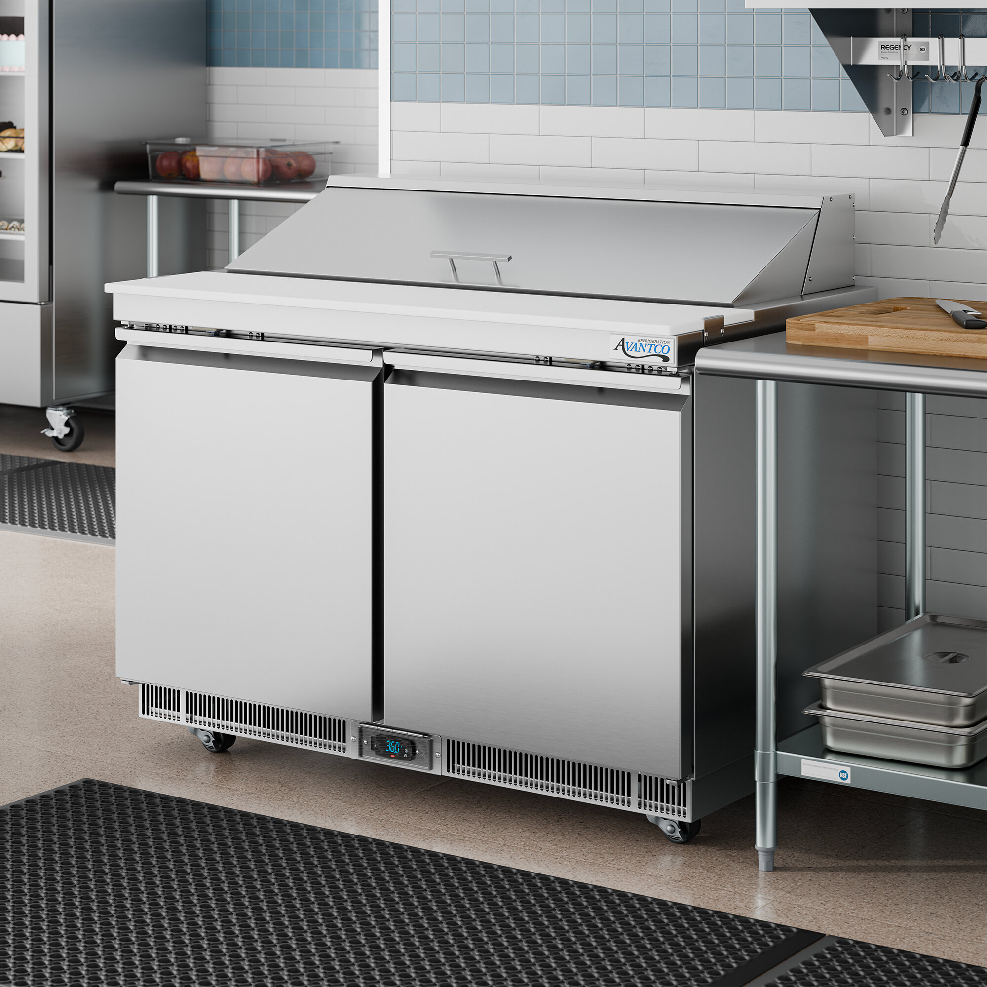 A stainless steel, two-door refrigerated sandwich prep table with a cutting top and front-breathing design.