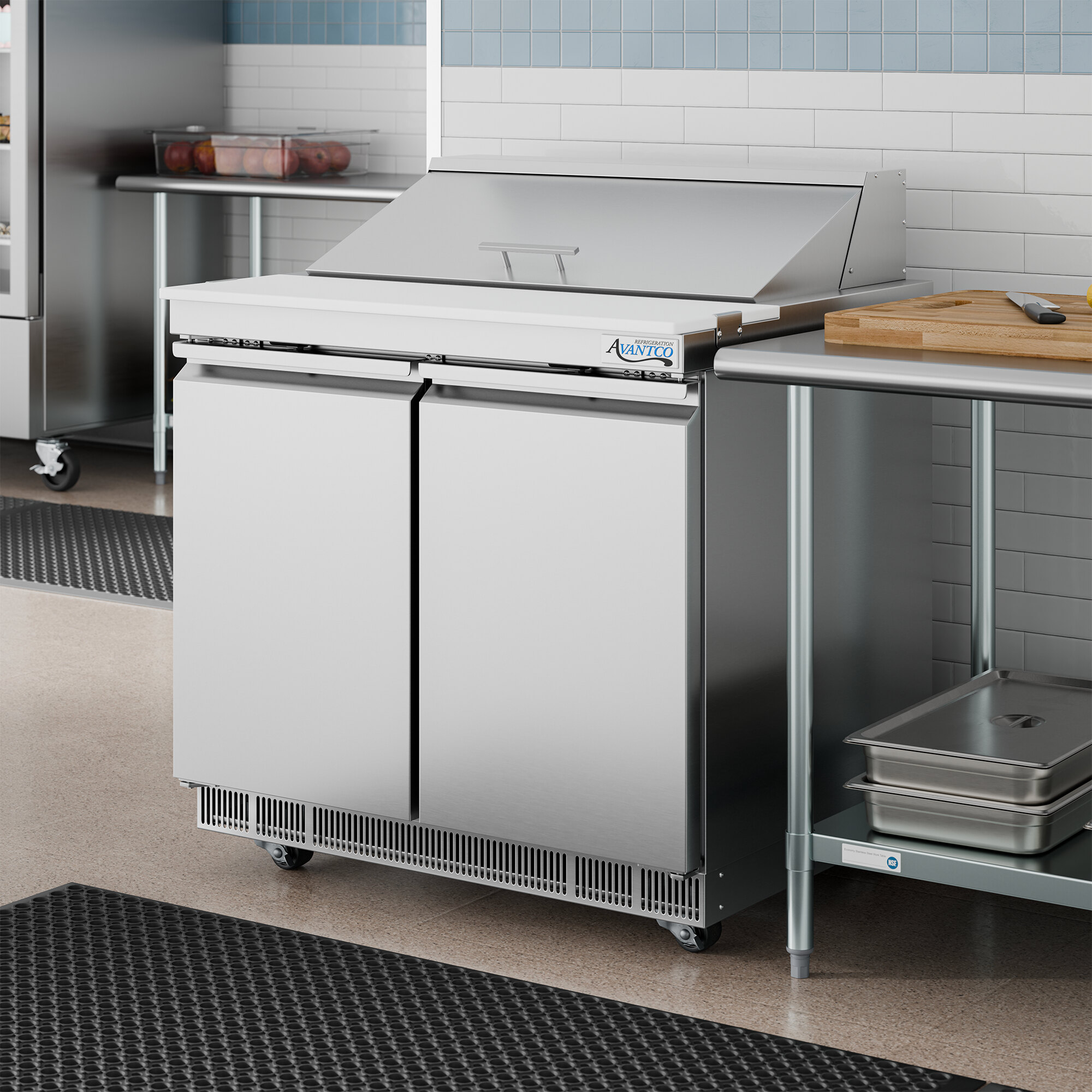 A stainless steel two-door refrigerated sandwich prep table with a cutting top.