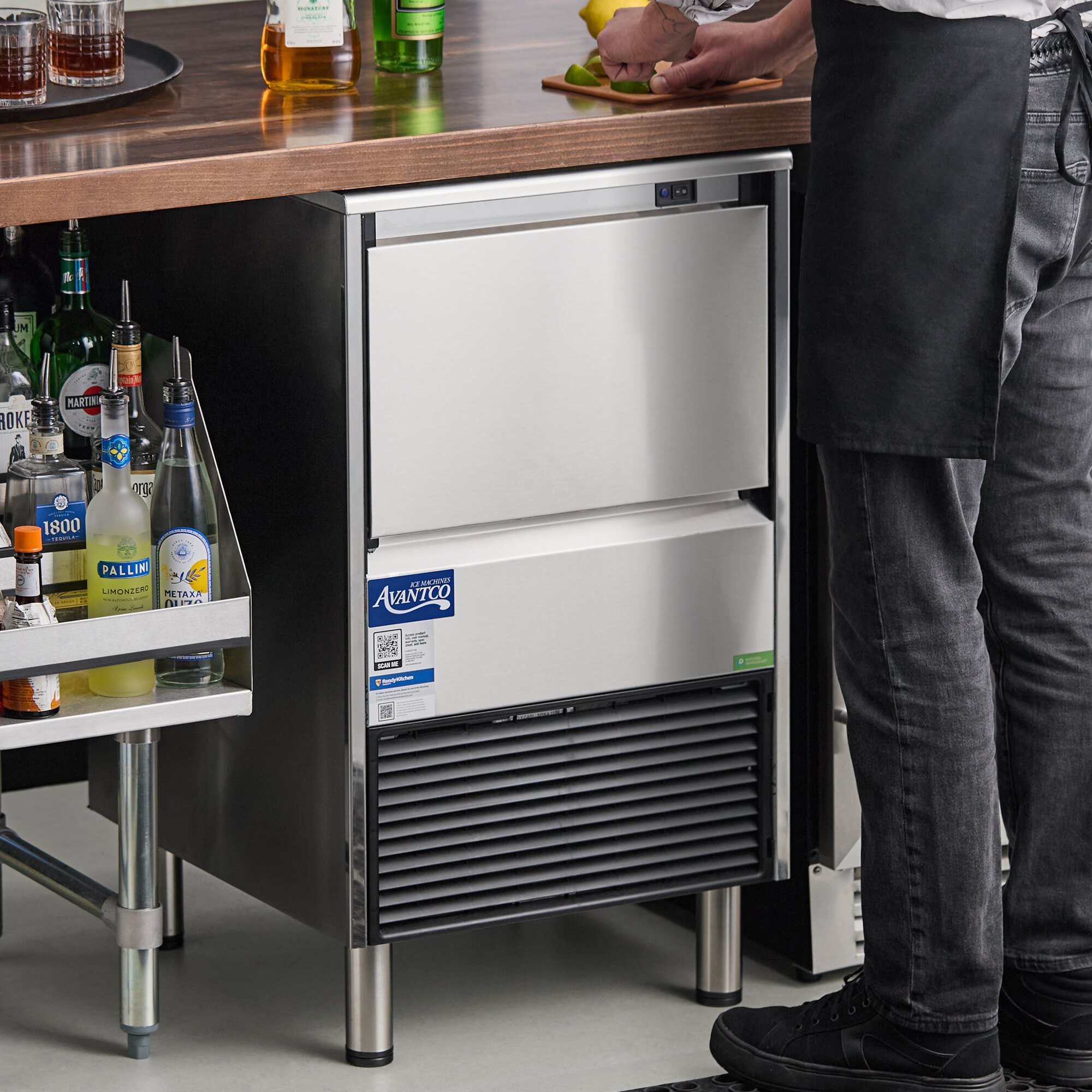 An undercounter air-cooled ice machine with a stainless steel exterior and a built-in ice storage bin.