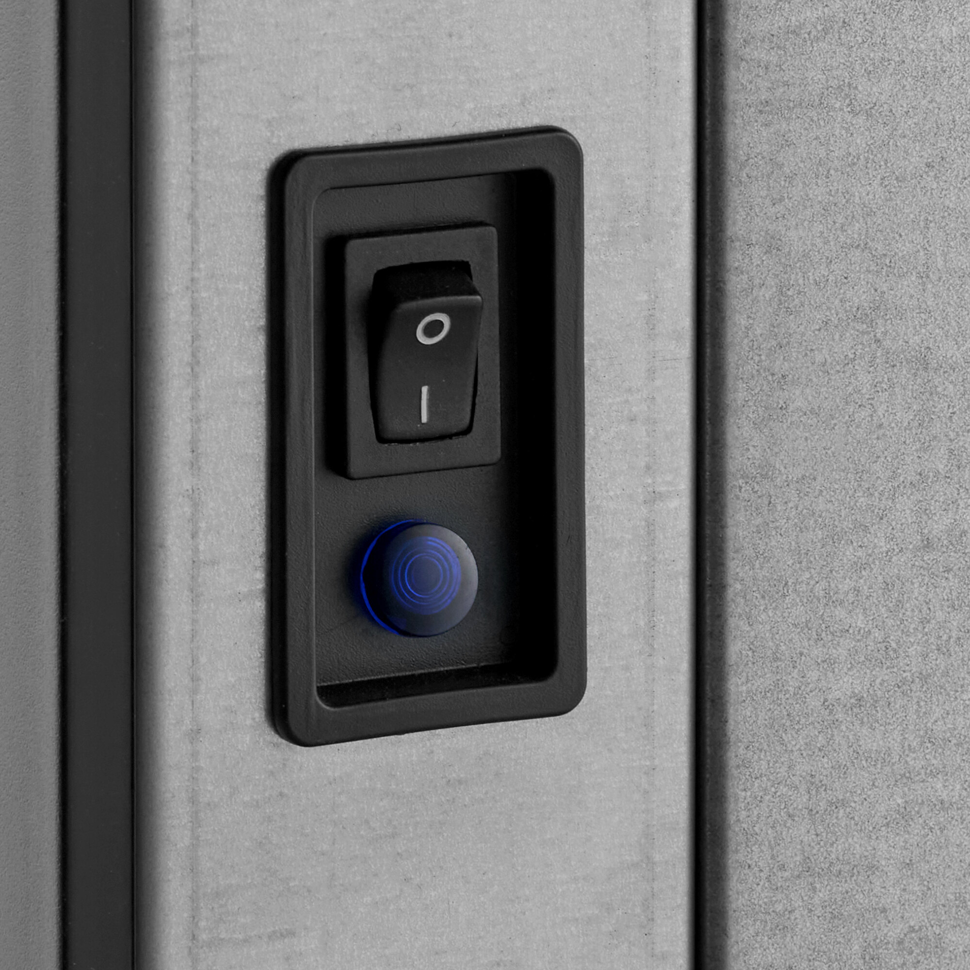 A close-up of a power switch and indicator light on an Avantco Ice Diamond EMC-H-422-A air-cooled modular half cube ice machine.