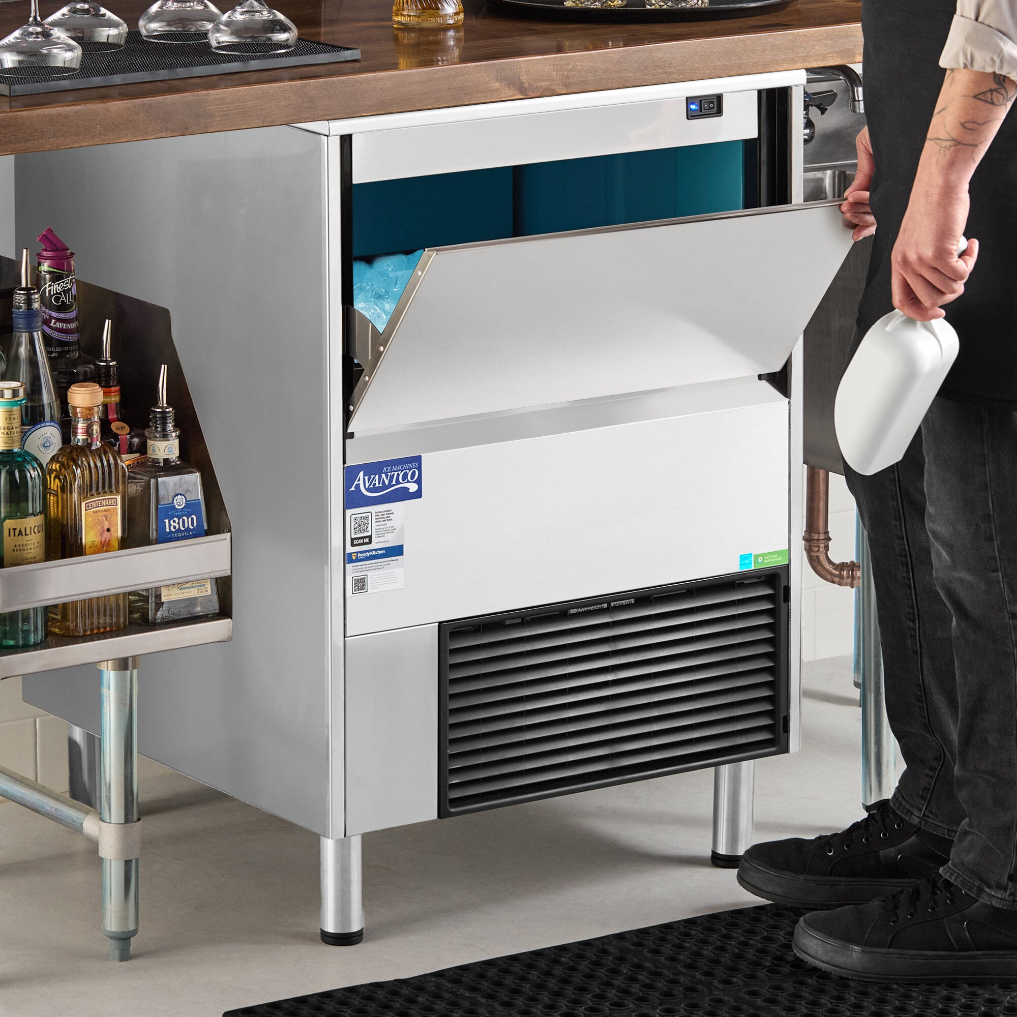 An undercounter air-cooled ice machine with a stainless steel exterior and a front-opening bin, designed for commercial use.