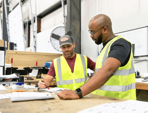 two webstaurant store employees in a warehouse