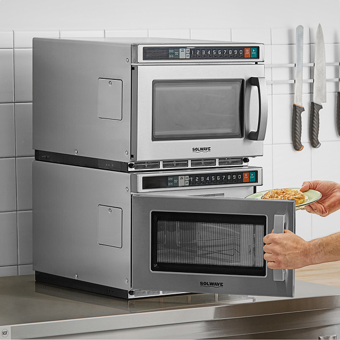 hand putting a plate into a Solwave microwave