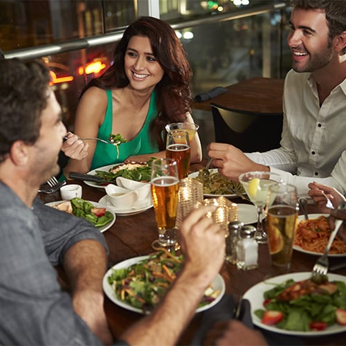 Friends sitting around a table eating