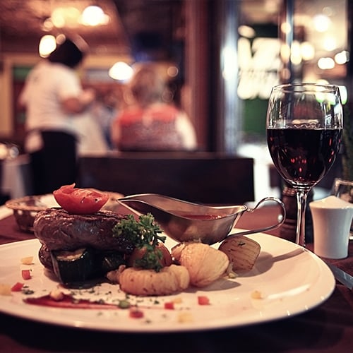 A steak dinner with wine