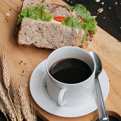 A cup of coffee and sandwich.