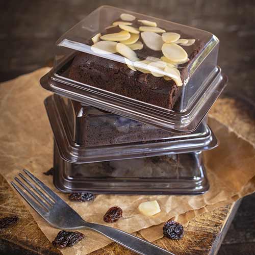 brownies with almond slices in individual plastic stacked containers