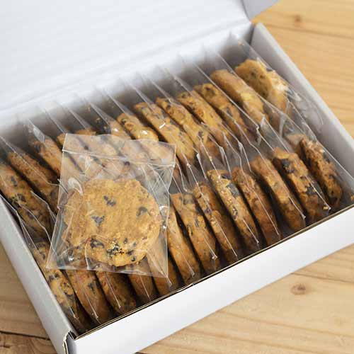 homemade cookies in plastic bags in cardboard box
