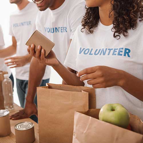 volunteers packing food and drinks for charity