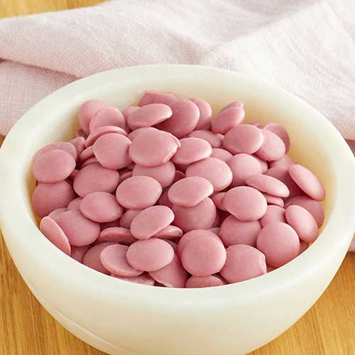 white bowl filled with ruby chocolates