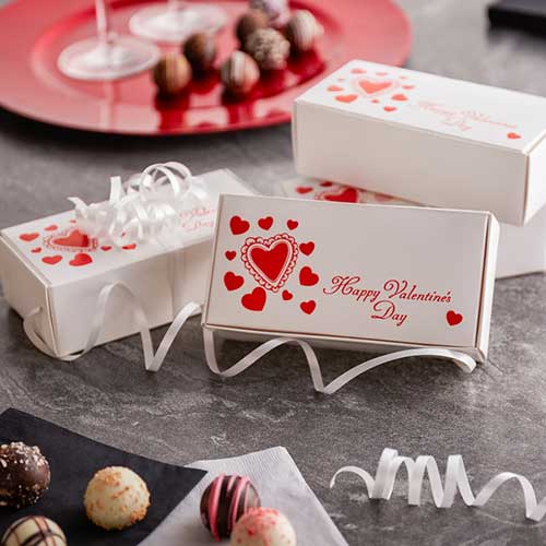 bakery box with red script that says happy valentines day