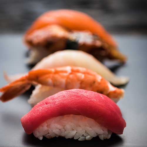 close up of sashimi sushi set on black tray