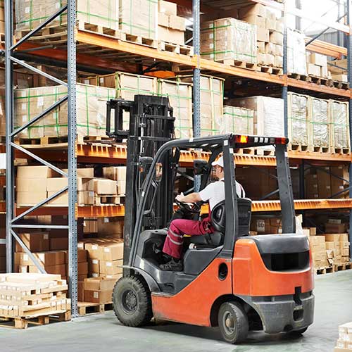 driver at warehouse using forklift loader