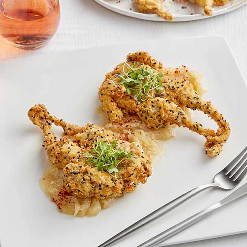 fried peppered quail on white plate