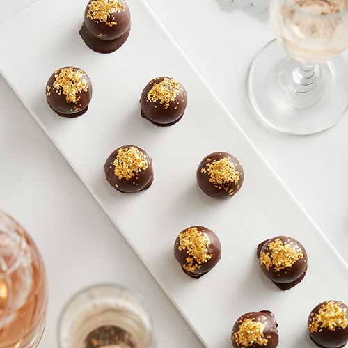 gold crumbs on top of chocolate balls
