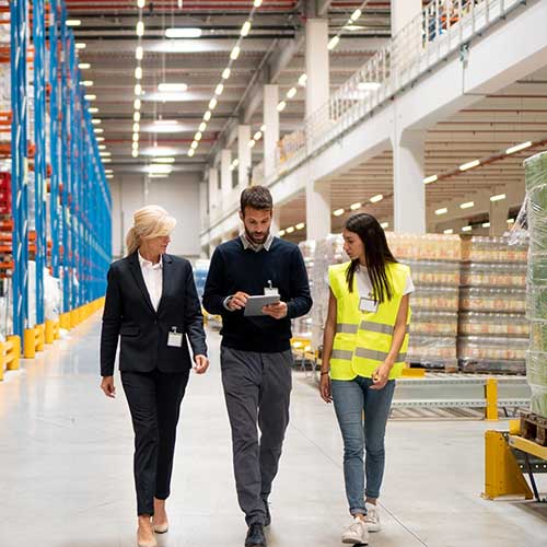 manager visiting warehouse and taking notes