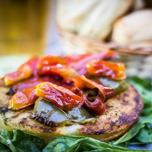 Grilled provoleta cheese adorned with grilled red peppers