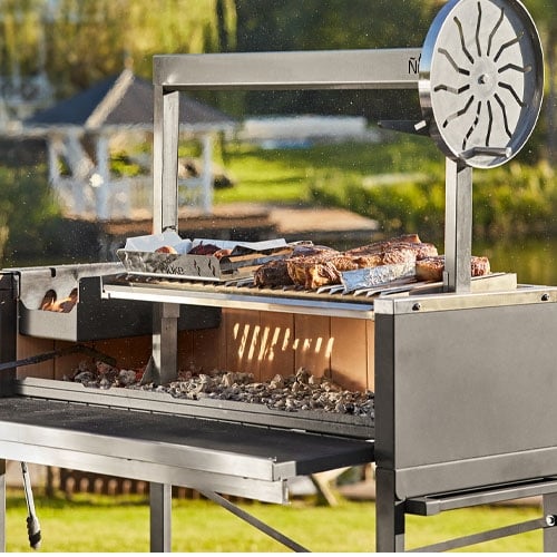 Asado meats grilling on a parilla grill