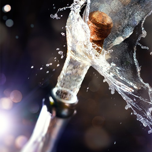Champagne cork exploding off the bottle