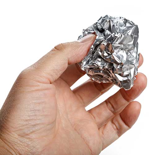 https://www.webstaurantstore.com/uploads/blog/2022/2/hand-holding-aluminum-foil-ball-min.jpg